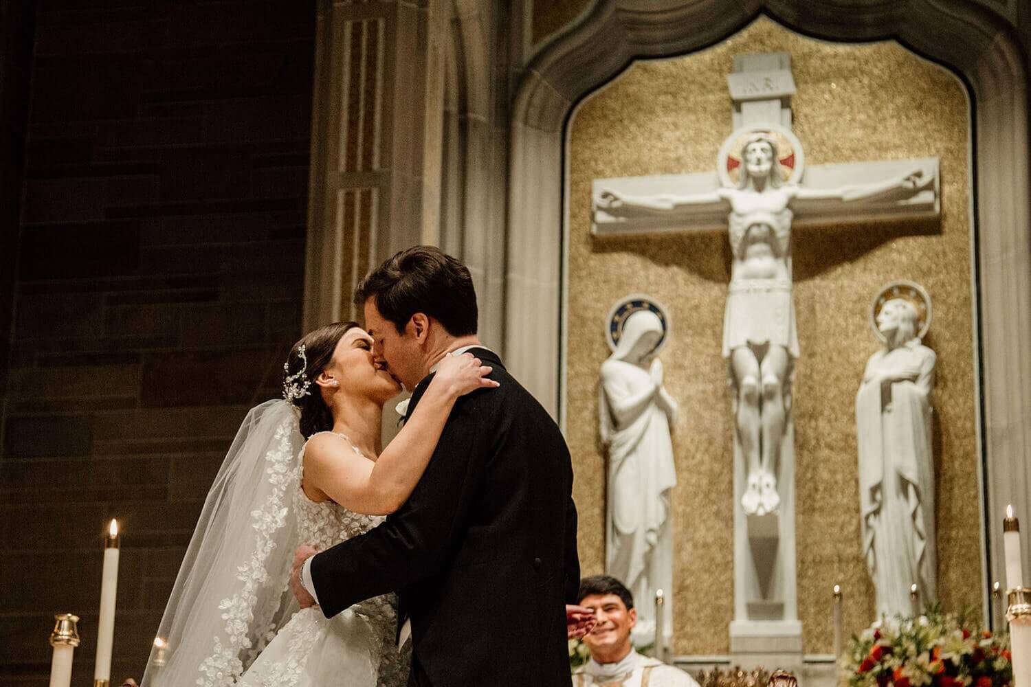 bride and groom kiss at the Cathedral of Christ the King
